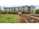Modern apartment building exterior with balconies and well-maintained landscaping at 2958 Syracuse St # 204, Denver, CO 80238