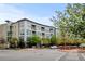 Modern apartment building featuring balconies, large windows, and landscaped surroundings in a vibrant urban setting at 2958 Syracuse St # 204, Denver, CO 80238