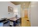 Warm and inviting hallway featuring hardwood floors, a desk, and recessed lighting at 2958 Syracuse St # 204, Denver, CO 80238