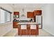 Modern kitchen with wood cabinets, granite countertops, and a stainless steel microwave oven at 2958 Syracuse St # 204, Denver, CO 80238