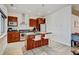 Kitchen featuring wood cabinets, granite countertops, and modern stainless steel appliances at 2958 Syracuse St # 204, Denver, CO 80238