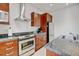 Galley kitchen featuring stainless steel appliances, granite countertops, and modern cabinetry for a sleek design at 2958 Syracuse St # 204, Denver, CO 80238