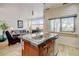 Living room view with a partial view of the kitchen island and chairs at 2958 Syracuse St # 204, Denver, CO 80238