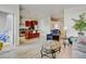 Open concept living area featuring a kitchen with an island, stainless appliances, and hardwood-style flooring at 2958 Syracuse St # 204, Denver, CO 80238