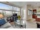 Bright living room featuring hardwood floors, large windows, and an open concept design with a modern kitchen at 2958 Syracuse St # 204, Denver, CO 80238