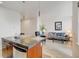 Open concept living and kitchen area showcasing hardwood floors, granite countertops, and modern stainless appliances at 2958 Syracuse St # 204, Denver, CO 80238