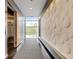 Contemporary lobby with an elevator and artistic wall design with a view to the outside at 2958 Syracuse St # 204, Denver, CO 80238