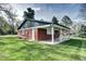 Red brick backyard building with a covered patio, great for outdoor entertaining at 10 Martin Ln, Cherry Hills Village, CO 80113