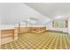Large bonus room with unique carpet and custom built-in shelving along the walls at 10 Martin Ln, Cherry Hills Village, CO 80113