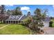 Elegant home with a sprawling lawn, mature landscaping, and a circular driveway at 10 Martin Ln, Cherry Hills Village, CO 80113