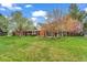 Well-manicured lawn and landscaping complement this beautiful brick home's exterior at 10 Martin Ln, Cherry Hills Village, CO 80113