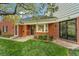 Charming brick home with a manicured lawn, mature trees, and a covered entry at 10 Martin Ln, Cherry Hills Village, CO 80113