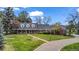Charming exterior of home with well-manicured lawn, mature trees, and inviting entrance at 10 Martin Ln, Cherry Hills Village, CO 80113