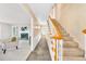Foyer featuring slate floors, staircase, view to a cozy sitting room with fireplace at 10 Martin Ln, Cherry Hills Village, CO 80113