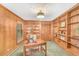Wood-paneled home office with extensive built-in shelving and a large desk at 10 Martin Ln, Cherry Hills Village, CO 80113