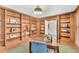 Charming home office featuring built-in bookshelves and a view of the home's interior at 10 Martin Ln, Cherry Hills Village, CO 80113