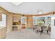 Eat-in kitchen featuring built-in desk, bay window overlooking backyard, and table with chairs at 10 Martin Ln, Cherry Hills Village, CO 80113