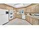 Traditional kitchen with beige cabinets, white appliances, double oven, and white countertops at 10 Martin Ln, Cherry Hills Village, CO 80113