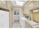 Laundry room with washer, dryer, sink, and white cabinets for ample storage at 10 Martin Ln, Cherry Hills Village, CO 80113