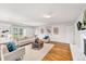 Bright living room with hardwood floors, neutral furniture, and sliding doors to backyard at 10 Martin Ln, Cherry Hills Village, CO 80113