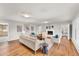 Bright living room with hardwood floors, white walls, a fireplace, and neutral-toned furniture and decor at 10 Martin Ln, Cherry Hills Village, CO 80113
