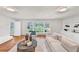 Inviting living room featuring hardwood floors, backyard views, and stylish decorations at 10 Martin Ln, Cherry Hills Village, CO 80113