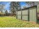 Well maintained green backyard storage shed surrounded by lush lawn and a wood fence at 12829 E Oregon Dr, Aurora, CO 80012