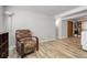 A basement area showcasing laminate flooring, chair, and views to a storage closet at 12829 E Oregon Dr, Aurora, CO 80012