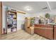 A basement storage space featuring shelving, storage containers, and a movable wooden cabinet at 12829 E Oregon Dr, Aurora, CO 80012