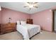 Comfortable bedroom featuring a ceiling fan, soft carpet, and ample storage space at 12829 E Oregon Dr, Aurora, CO 80012