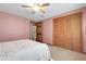 Inviting bedroom boasts a ceiling fan, carpet floors and a closet with wooden doors at 12829 E Oregon Dr, Aurora, CO 80012
