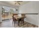 Dining area with hardwood table, chairs, and access to the deck through glass sliding doors at 12829 E Oregon Dr, Aurora, CO 80012