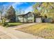 Attractive home with attached garage, a well-manicured lawn and mature landscaping at 12829 E Oregon Dr, Aurora, CO 80012