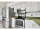 The kitchen features stainless appliances and ample cabinet space at 12829 E Oregon Dr, Aurora, CO 80012