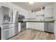 Stainless steel appliances and white cabinets accent the updated kitchen at 12829 E Oregon Dr, Aurora, CO 80012