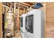Laundry area with modern washer and dryer, water heater, and hanging storage for clothes at 12829 E Oregon Dr, Aurora, CO 80012