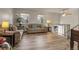 A view of a living room featuring neutral decor, laminate floors, and views to a staircase at 12829 E Oregon Dr, Aurora, CO 80012