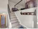 Well lit staircase leads to the second floor with updated railing and wood floors at 12829 E Oregon Dr, Aurora, CO 80012