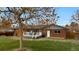 Home's exterior features brick, white trim, and wooden deck at 4262 E Fremont Pl, Centennial, CO 80122