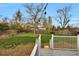 Backyard featuring lush lawn, wooden fence, and mature trees at 4262 E Fremont Pl, Centennial, CO 80122