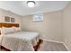 Simple finished basement bedroom features natural light and neutral colored walls and carpet at 4262 E Fremont Pl, Centennial, CO 80122