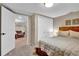 Cozy bedroom with a double bed, closet, and doorway to living room in finished basement at 4262 E Fremont Pl, Centennial, CO 80122