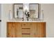 Bathroom featuring dual mirrors, double vanity, white subway tile and gold accents at 4262 E Fremont Pl, Centennial, CO 80122