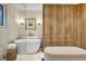 Modern bathroom boasts a freestanding tub, natural wood accents and sleek fixtures, creating a spa-like retreat at 4262 E Fremont Pl, Centennial, CO 80122