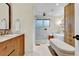Bright bathroom highlighting dual vanity, stand alone tub and glass shower at 4262 E Fremont Pl, Centennial, CO 80122