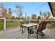 Back deck features wood floors, white railings and an outdoor dining set at 4262 E Fremont Pl, Centennial, CO 80122
