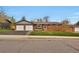 Well-maintained brick home with a two-car garage and landscaped front yard at 4262 E Fremont Pl, Centennial, CO 80122