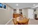 Basement game room boasts a wet bar with shelving, mini fridge, and a round table at 4262 E Fremont Pl, Centennial, CO 80122