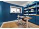 Modern home office features custom built-in bookshelves, wood desktop, and a large window at 4262 E Fremont Pl, Centennial, CO 80122