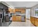 Well-lit kitchen with stainless steel appliances and wood cabinets at 4262 E Fremont Pl, Centennial, CO 80122